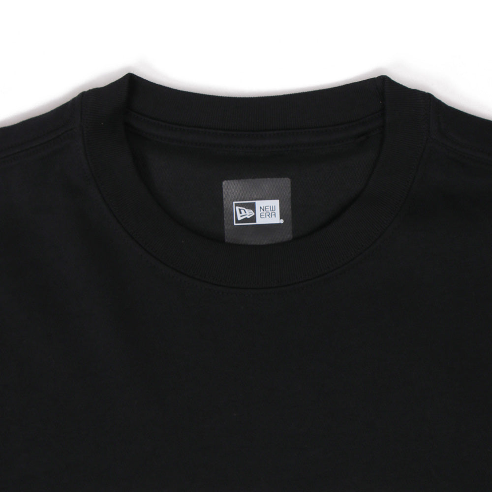 Black t-shirt with a brand logo on the collar against a white background