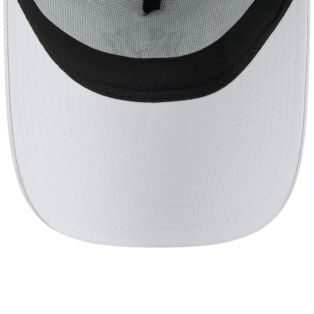 Close-up of a white cap with black mesh back on a white background